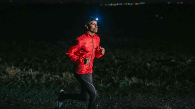 Man running at night with light